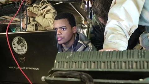 Soldiers operate Mission Command Workstation computers at base camp Stock Footage 102097047