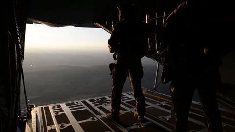 Soldiers perform static line jump from C-130 Hercules Stock Footage 104803406