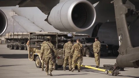 Soldiers place elevators on Apache helicopter Stock Footage 113297902