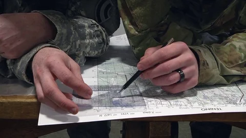 Soldiers plotting map during land navigation course Stock Footage 88577232