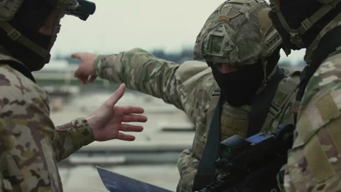 Soldiers pointing and looking at map Stock Footage 275094545