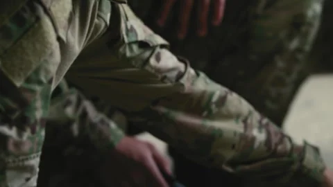 Soldiers pointing with laser pointer at map on ground Stock Footage 275093843