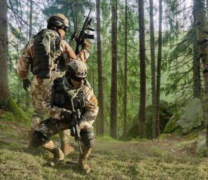 Soldiers posing in forest. Stock Photos