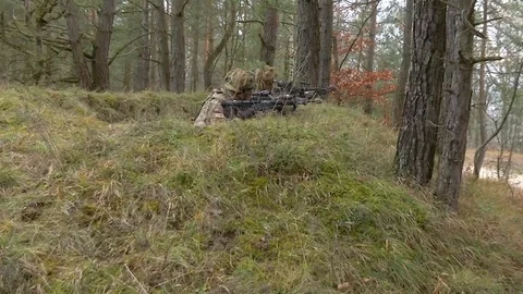 Soldiers practice aiming and ducking inside a trench Stock Footage 113296940