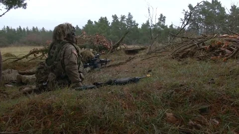 Soldiers practice aiming and ducking on a small hill Stock Footage 113296987