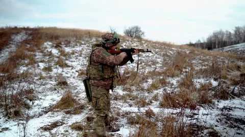 Soldiers practice shooting with machine guns on a military field Video stock 288825354