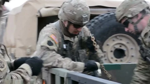 Soldiers preparing chains for sling load operation Stock Footage 87458772