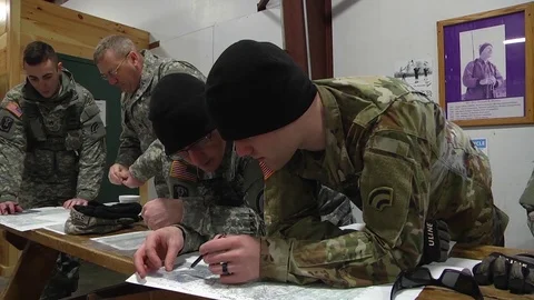 Soldiers reading map during land navigation course Stock Footage 88577218