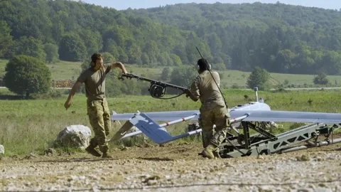 Soldiers remove engine starter from Tactical unmanned aircraft system for launch Stock Footage 260385552