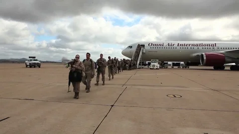 Soldiers return from deployment overseas to reunite with their families. Stock Footage
