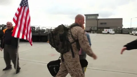 Soldiers return from deployment overseas to reunite with their families. Stock Footage