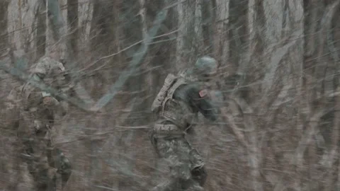 Soldiers run through the forest Stock Footage 131093239