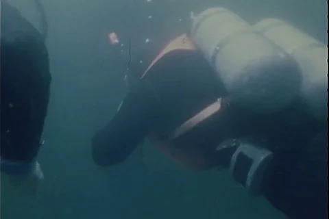 Soldiers scuba diving in the ocean during Exercise Reforger - 1974 Stock Footage 112194846