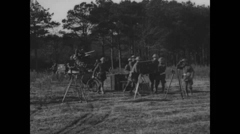 Soldiers setting up and testing 3-4 inch anti-aircraft gun and meter on tripod Stock Footage 43319343