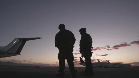 Soldiers shadows next to airplane Stock Footage 274354635