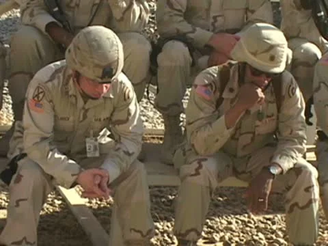 Soldiers sitting and some taking pictures during service outside Stock Footage 8950853