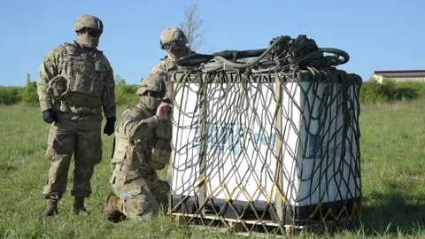 Soldiers Sling Loading Supplies Video stock 136778218