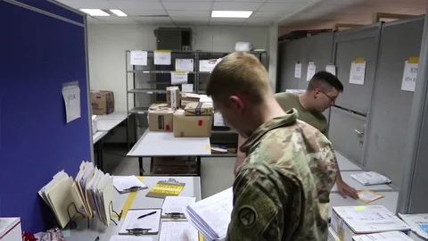 Soldiers sorting paperwork in mailroom at Camp Arifjan, Kuwait 스톡 동영상 98867249