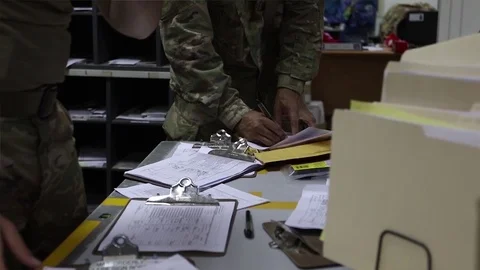 Soldiers sorting paperwork in mailroom at Camp Arifjan, Kuwait 스톡 동영상 98867251
