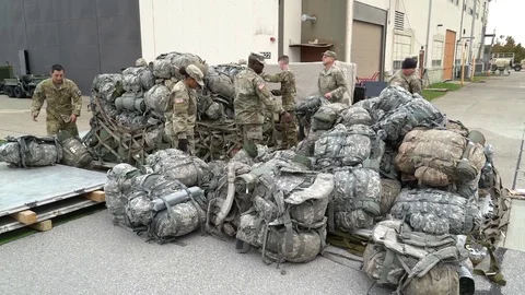 Soldiers stack baggage for deployment at Southwest Border for Faithful Patriot Stock Footage 97566875