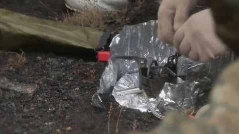 Soldiers start fire on the ground surrounded by a platoon Stock Footage 114017928