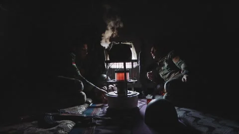Soldiers talking and drinking tea in a dark tent Stock Footage 330565558