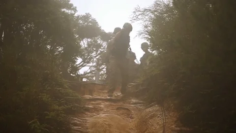 Soldiers train climbing down hill wall with assault rifles 2 Stock Footage 109575017