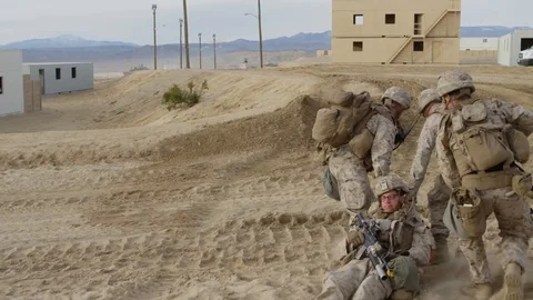 Soldiers train dragging wounded partner with assault rifles Stock Footage 110826091