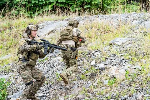 Soldiers training in a forest area during a military exercise in a rocky te.. Stock-Fotos
