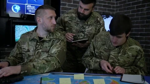 Soldiers in uniform, working in digital tablet, notebook and laptop, in military Stock Footage