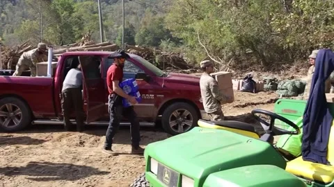Soldiers unload and stack supplies for residents in wake of Hurricane Helena Video stock 288083559