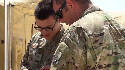 Soldiers using laptop computer during communications system setup Stock Footage 92522809