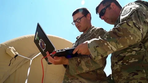 Soldiers using laptop computer during communications system setup Stock Footage 92522810