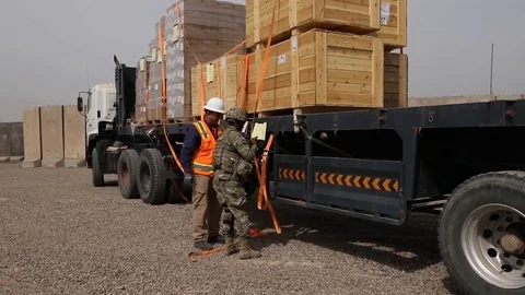 Soldiers using ratchet straps to secure load Stock Footage 87825934