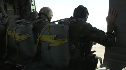 Soldiers waiting to perform static line parachute jump from UH-60 Black Hawk Stock Footage 114490128