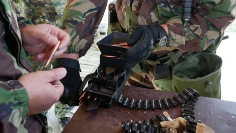 Soldiers in war load weapons bullets Stock Footage 143637664