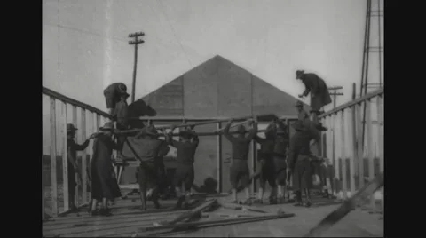 Soldiers working on construction of portable barracks Stock Footage