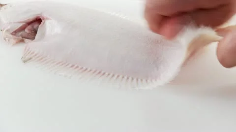 Sole being prepared - removing the skin Stock Footage 24644703