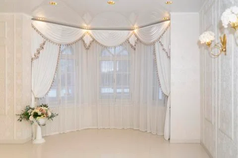 A solemn hall with old rounded windows and elegant interior in soft colors 库存照片