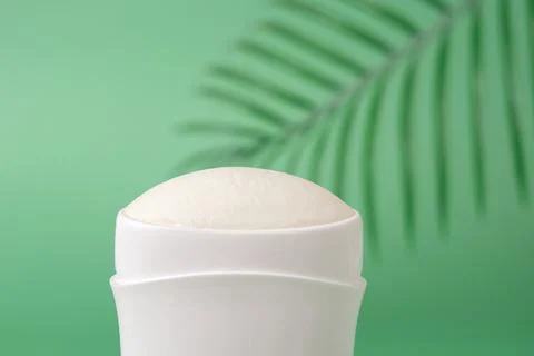Solid antiperspirant macro against green background. Body deodorant. Stock Photos