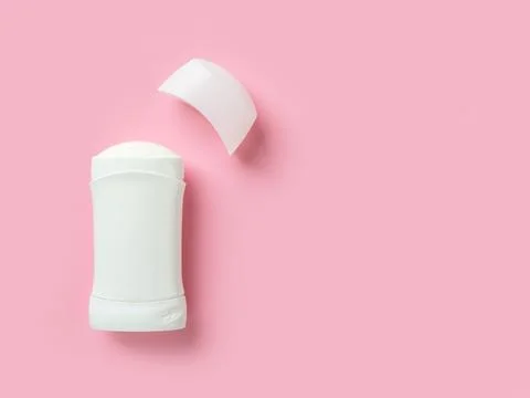 Solid antiperspirant over pink background with copy space. 库存照片