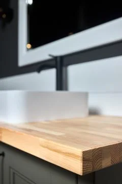 Solid ash glued timber under varnish edge corner table top selective focus macro Stock Photos