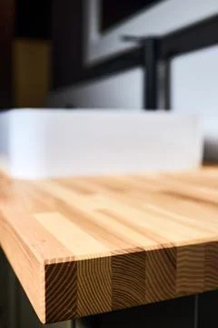 Solid ash glued timber under varnish edge corner table top selective focus ma Stock Photos