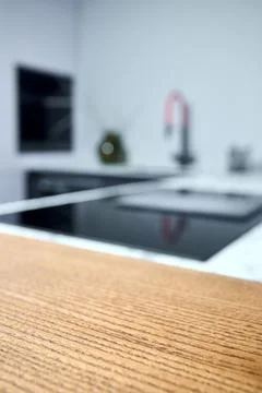 Solid ash glued timber under varnish edge corner table top selective focus ma Stock Photos