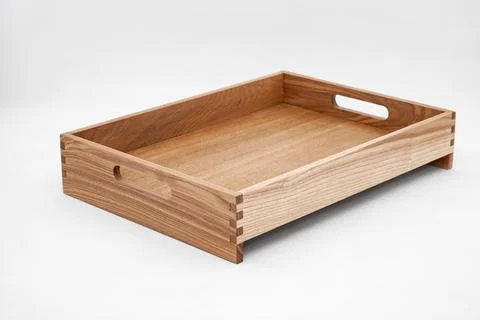 Solid ash wood tray with dovetail joints and cutout handles 스톡 사진