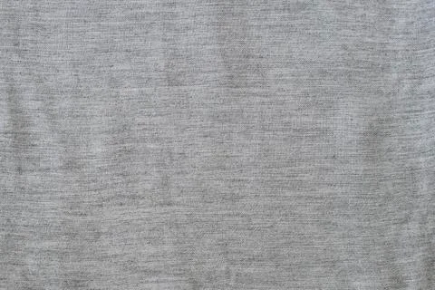 Solid background from a gray textured fabric. Close-up. Stock Photos