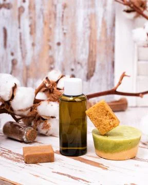 Solid bars of organic shampoo and bottle of shower gel. Stock Photos