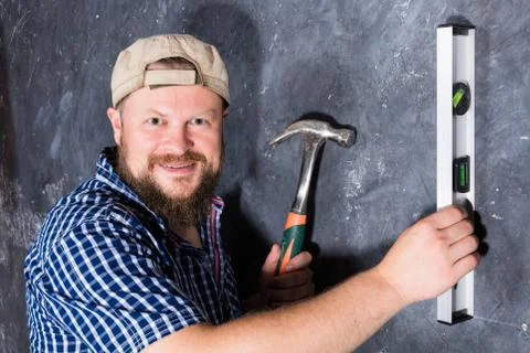 Solid bearded foreman with plumb and hammer Stock Photos