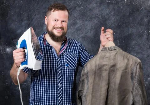 Solid bearded man at casual clothes having fun with iron Stock Photos