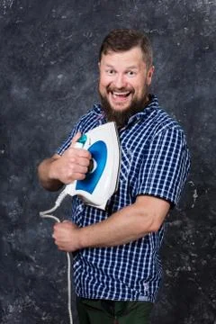 Solid bearded man at casual clothes having fun with iron Stock Photos